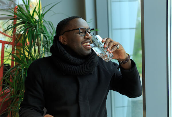 A man drinking a glass of water
