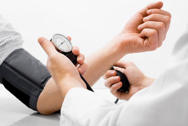 A Doctor checking blood pressure of a patient