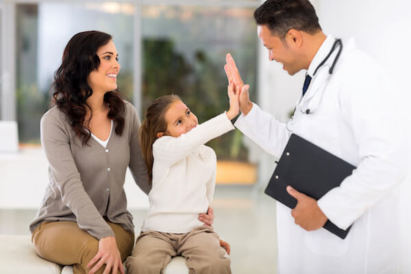 A Doctor and a child giving high five