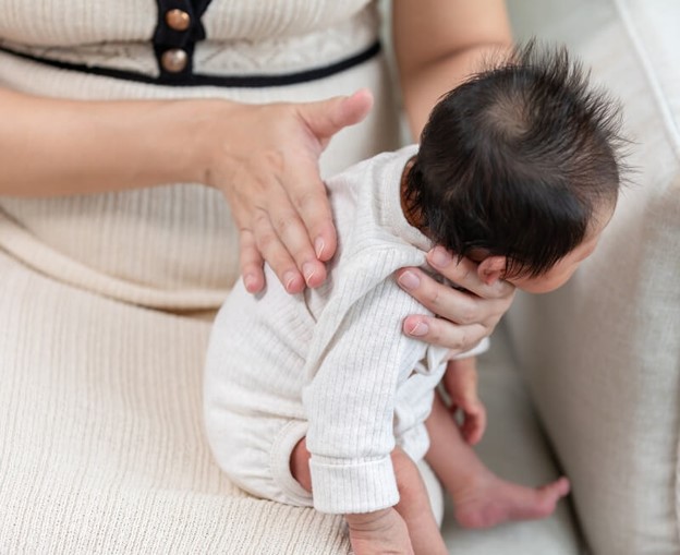 Mother Patting Newborn Baby’s back – Brevard Health Alliance