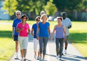 A group of retirement-aged adults walking together in a park