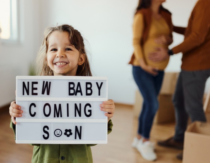 Family announcing arrival of a new baby