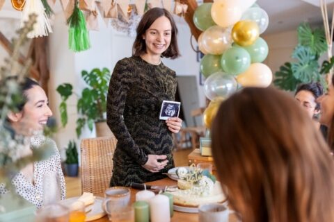 Woman announcing her Pregnancy with friends & family