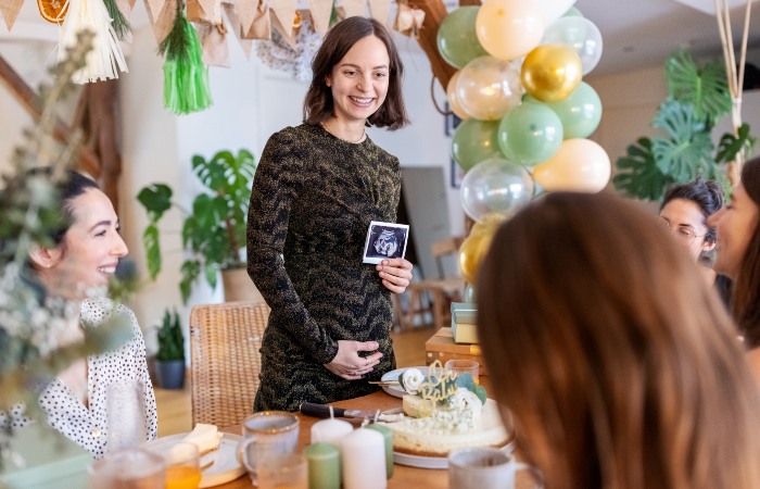 Woman announcing her Pregnancy with friends & family